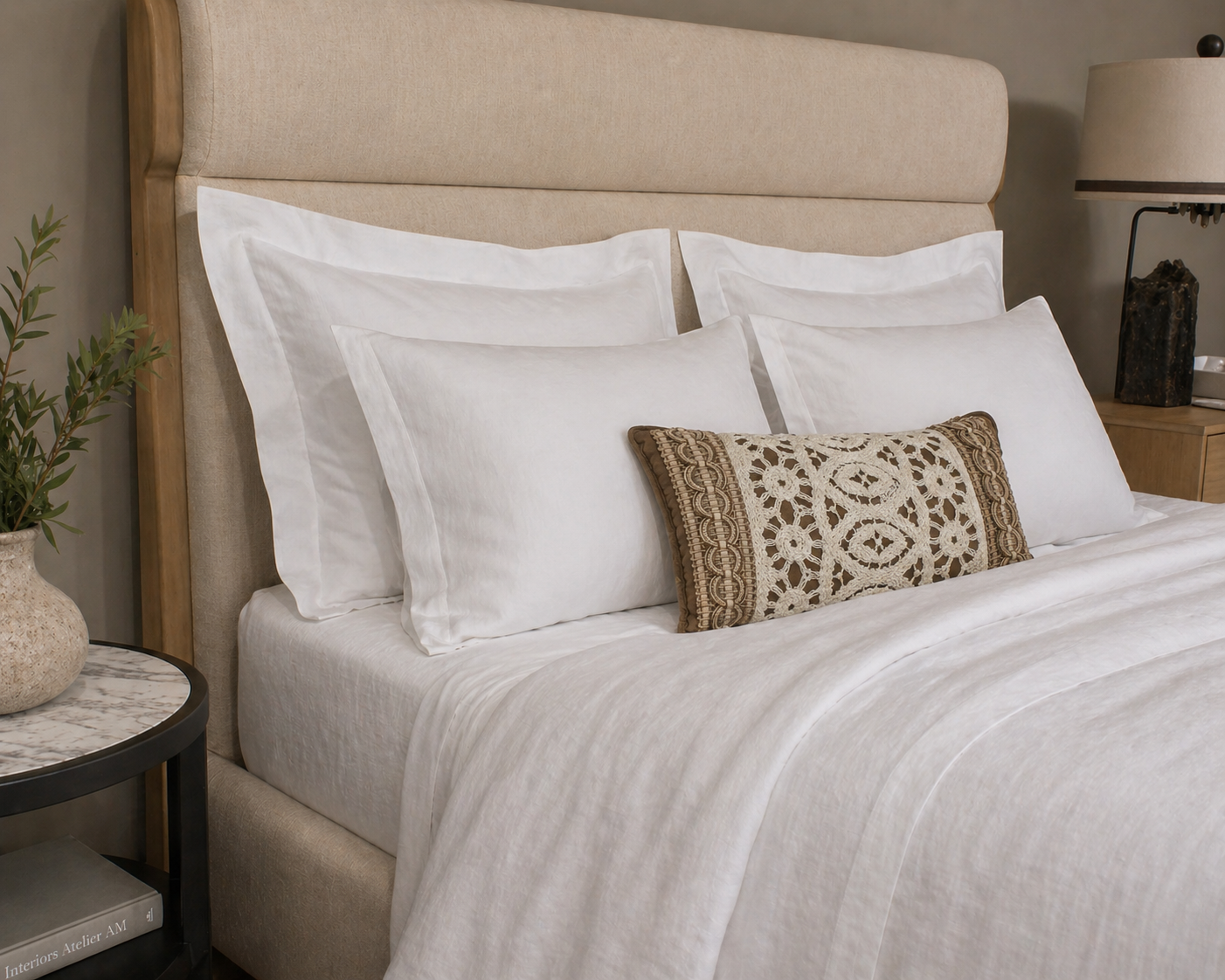 A quintus bed with Kearsley hite Belgian linen Euro Shams and Cynthia Scroll linen Quen shams with Antique creole lace pillow on charlotte white linen sheets and d
uvet cover.
