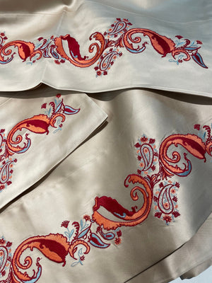 Kearsley Luxurious Montecito Sateen in a champagny silvery color we call Dream with Heather Kearsley Wolf designed Paisley in orange, brick red and a minty grean