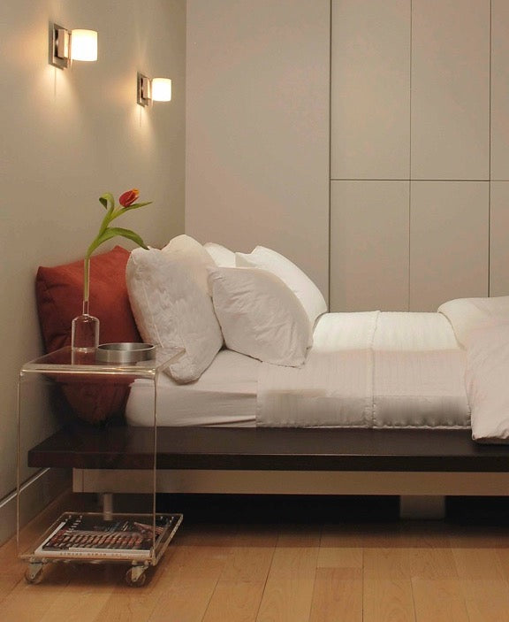 Side view White bedding in a very modern bedroom in NYC
