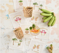 Set of eight white Kim Seybert Mingle cocktail napkins with colorful hand-embroidered celebratory phrases.