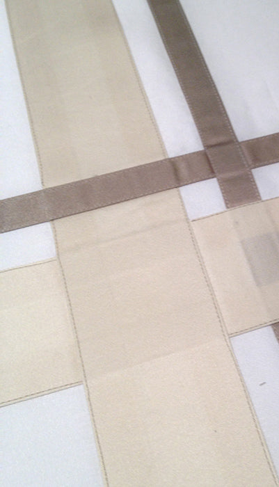 Ivory and Taupe Essntials Sateen stripes on white ground in overlapping appliqué for a future king's crib.  Royal bedding