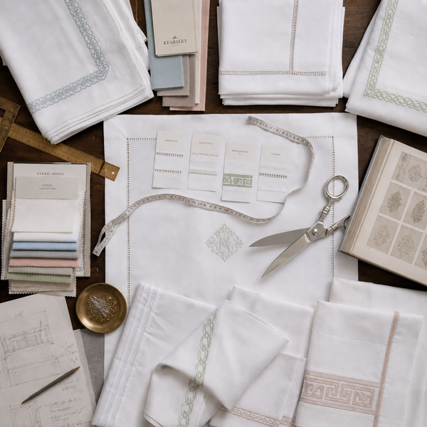 Tools of the trade at kearlsy cutting sam[lpes, sketches and embroidery samples ready to meet with private clients and interior designers.